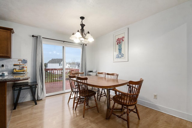 dining room with a chandelier and light hardwood / wood-style floors