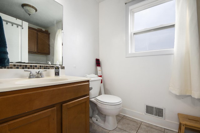 bathroom with backsplash, tile patterned flooring, vanity, and toilet