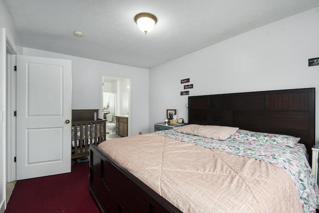 carpeted bedroom featuring ensuite bath