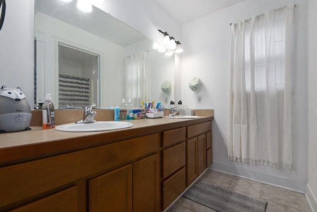 bathroom with tile patterned floors, shower / tub combo with curtain, and vanity