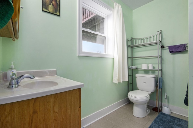 bathroom featuring tile patterned floors, vanity, and toilet