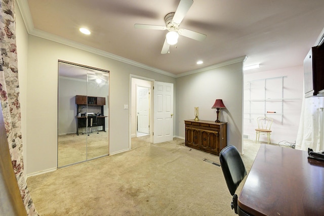 office space featuring ceiling fan, ornamental molding, and light carpet