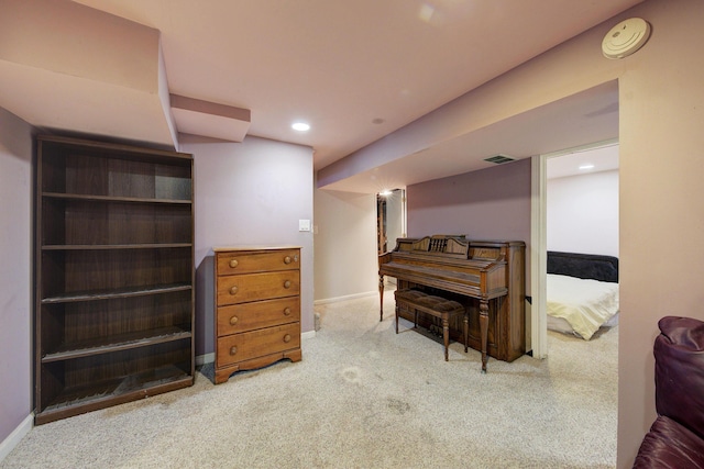 miscellaneous room featuring light colored carpet