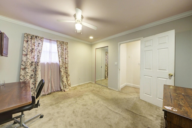 office area featuring ceiling fan, ornamental molding, and light carpet