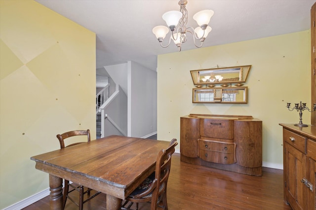 dining room featuring dark hardwood / wood-style flooring and an inviting chandelier