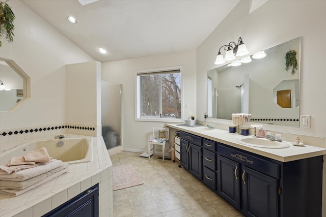 bathroom with plus walk in shower and vanity