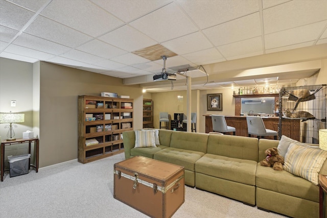 carpeted living room featuring a paneled ceiling