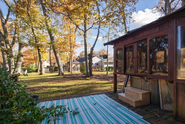 wooden terrace with a lawn