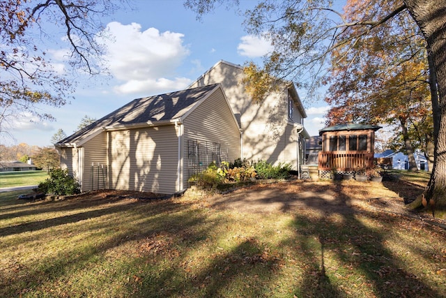 view of property exterior featuring a lawn and a wooden deck