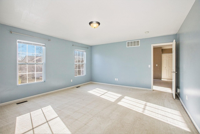 empty room with light colored carpet