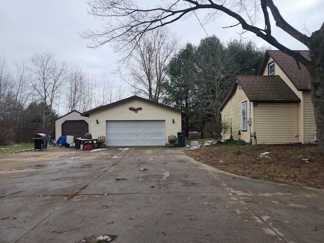 view of property exterior featuring an outdoor structure and a garage