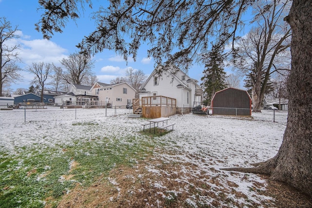 snowy yard with a deck