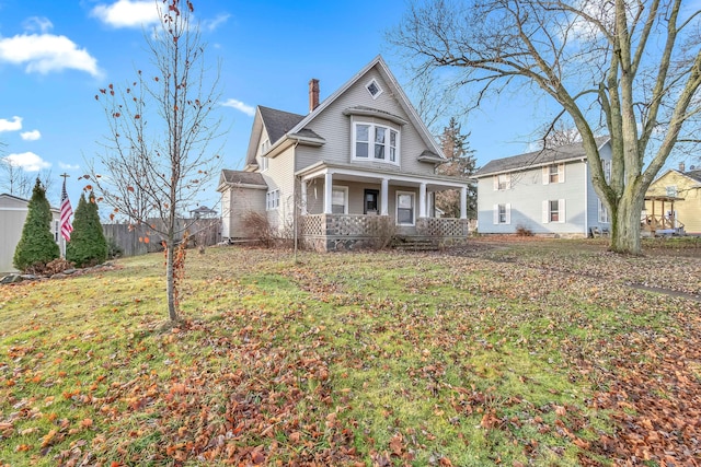 view of front of property with covered porch and a front lawn