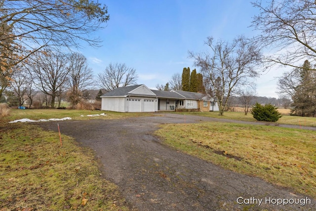 ranch-style house with a garage and a front yard