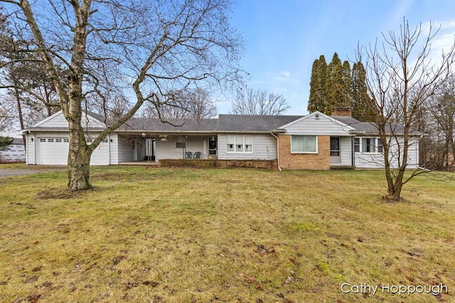 ranch-style house with a garage and a front lawn