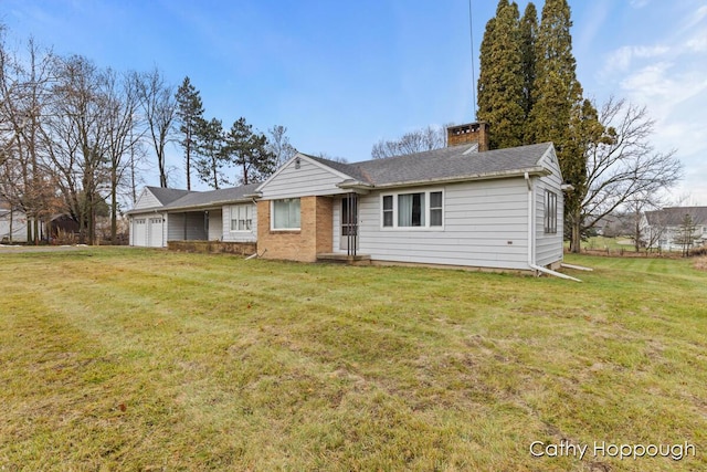 single story home featuring a front yard and a garage