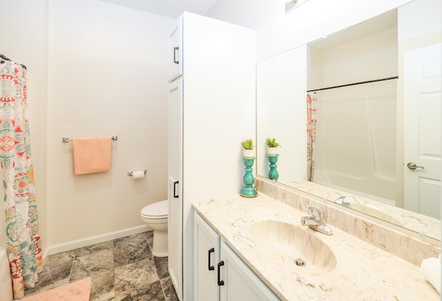 bathroom featuring vanity, toilet, and walk in shower