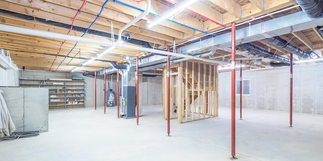 basement featuring gas water heater and heating unit