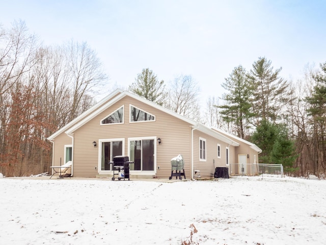 view of snow covered back of property