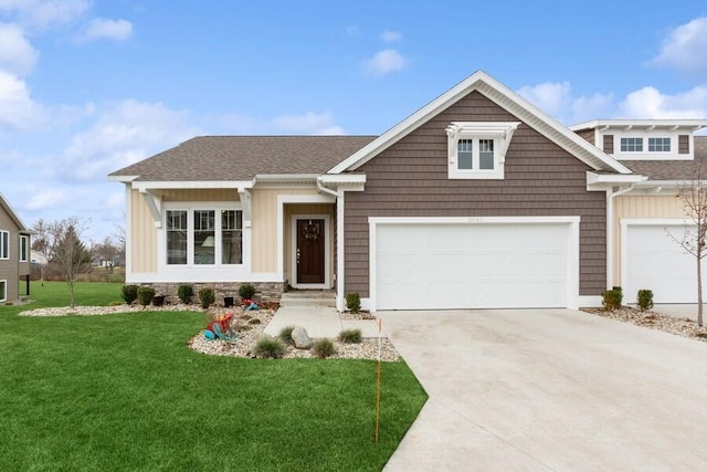 craftsman house with a garage and a front lawn