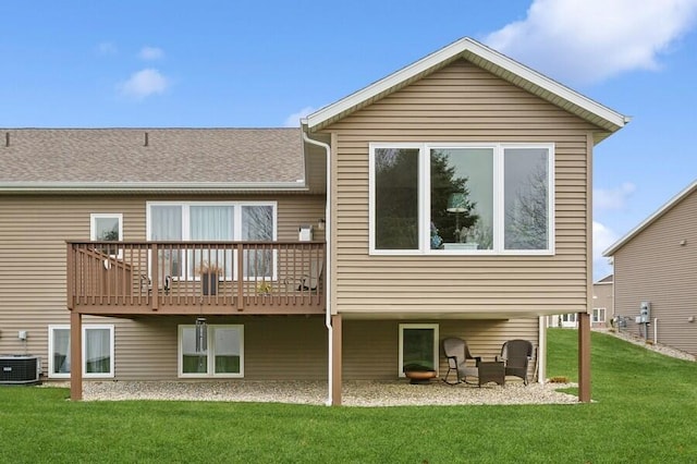 back of house with cooling unit and a yard