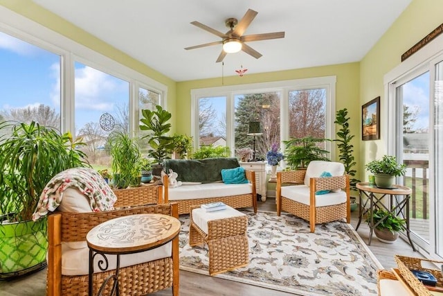 sunroom / solarium featuring ceiling fan