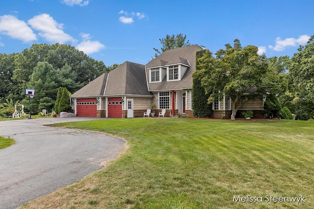 view of front of property with a front yard and a garage