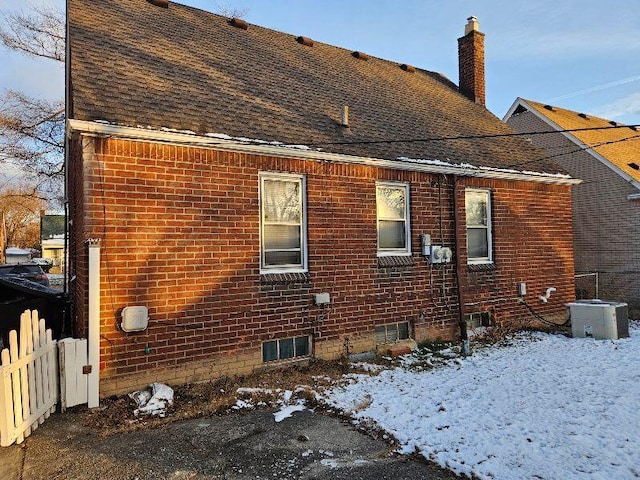 view of snowy exterior with central air condition unit