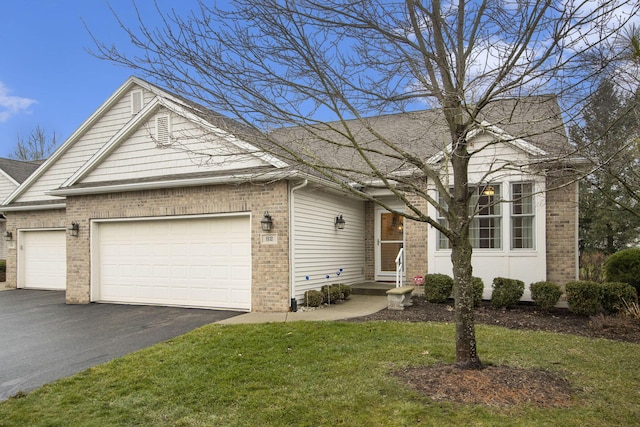 view of front of home featuring a front yard and a garage