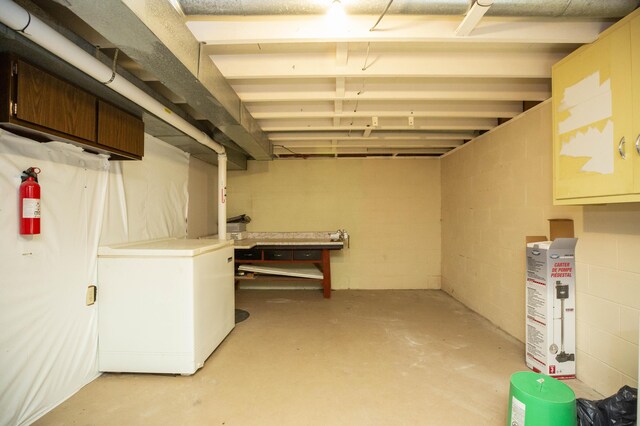 basement featuring fridge