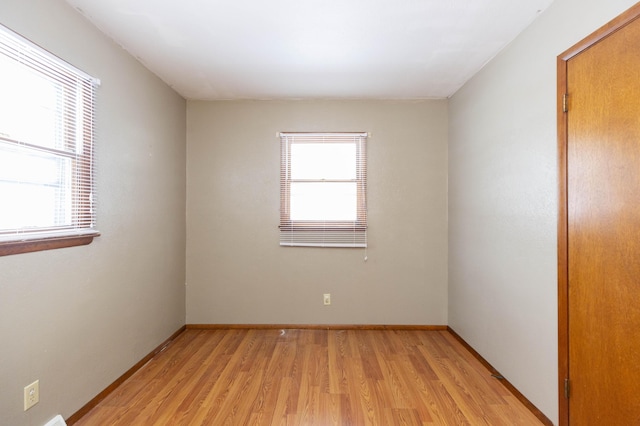 empty room featuring light hardwood / wood-style floors and a wealth of natural light