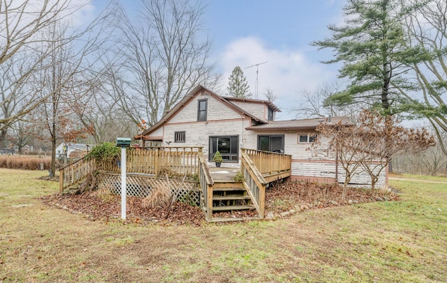 back of house featuring a wooden deck and a yard