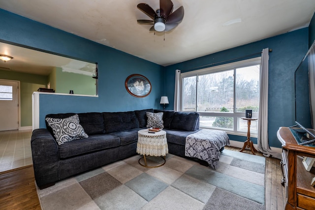 living room with a wealth of natural light, ceiling fan, and wood-type flooring