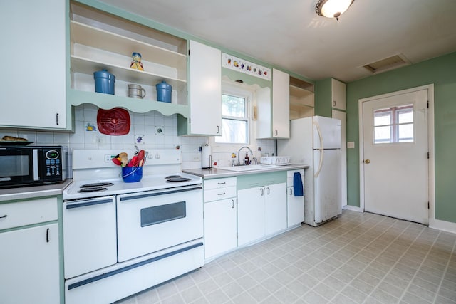 kitchen with white cabinets, white appliances, plenty of natural light, and sink