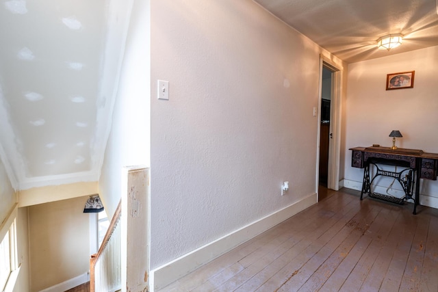 interior space with wood-type flooring and crown molding