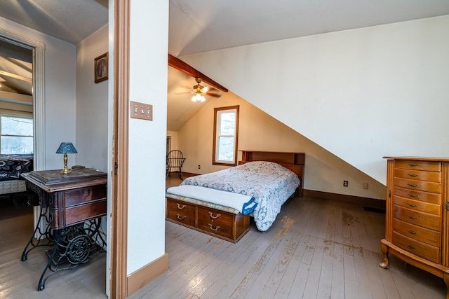 bedroom featuring vaulted ceiling and light wood-type flooring