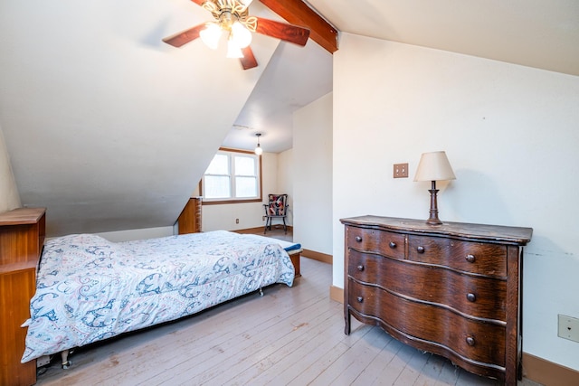 bedroom with vaulted ceiling with beams, ceiling fan, and light wood-type flooring