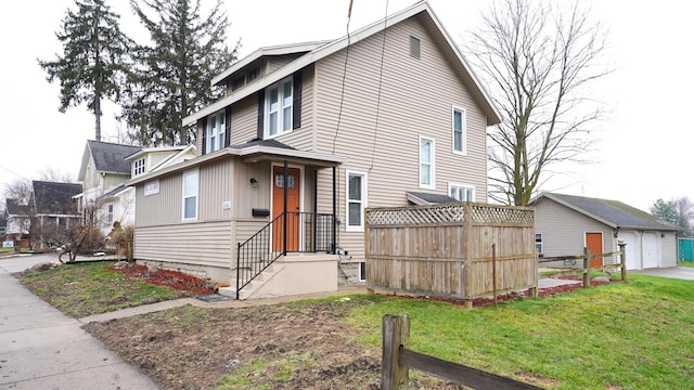 view of front facade with a garage, an outdoor structure, and a front lawn