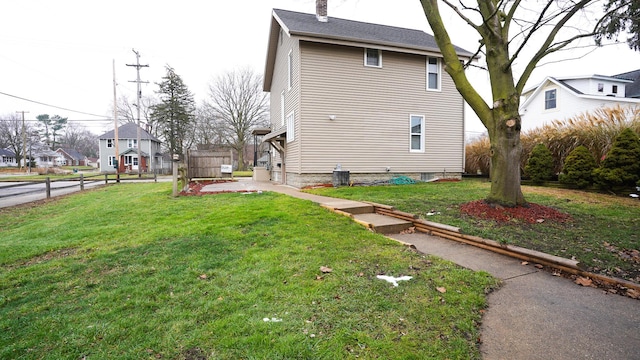 view of home's exterior with cooling unit, a patio area, and a lawn