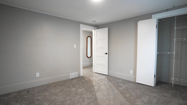 unfurnished bedroom featuring a closet and carpet