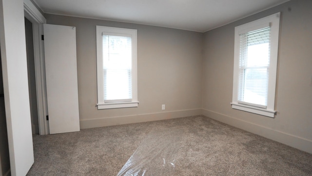 empty room with carpet and a healthy amount of sunlight