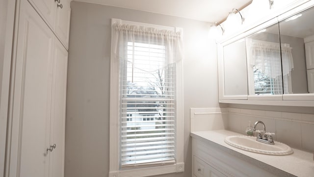 bathroom with vanity and decorative backsplash