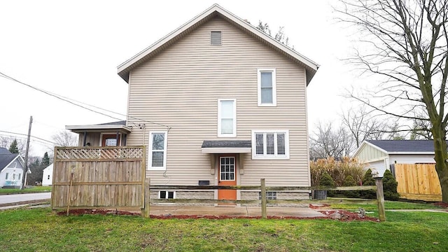 rear view of property featuring a yard