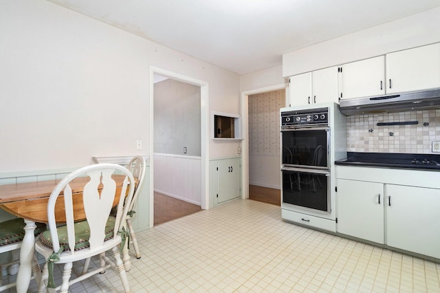 kitchen with black appliances and white cabinets