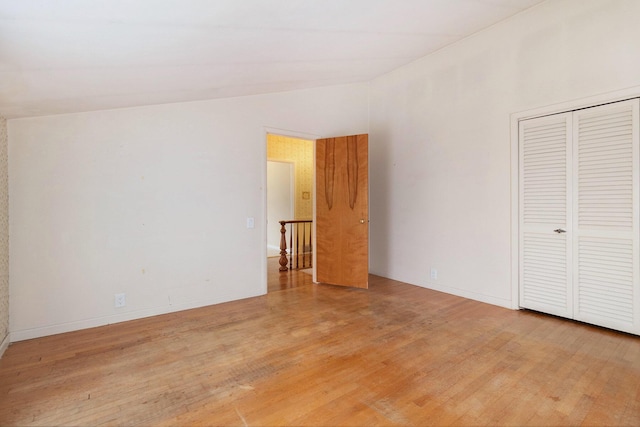 unfurnished bedroom with hardwood / wood-style flooring and a closet