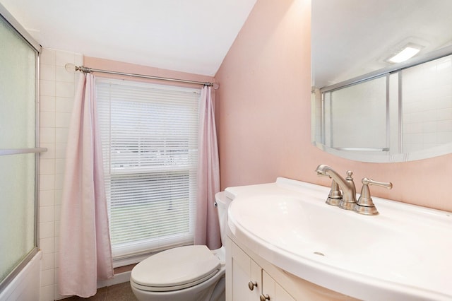 full bathroom featuring vanity, shower / bath combination, vaulted ceiling, and toilet