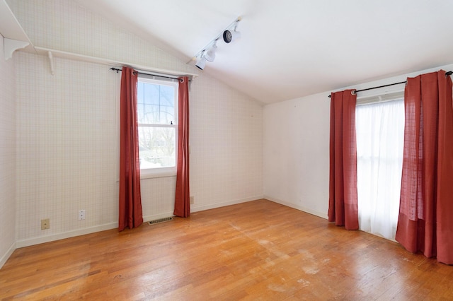 bonus room with light hardwood / wood-style floors and lofted ceiling