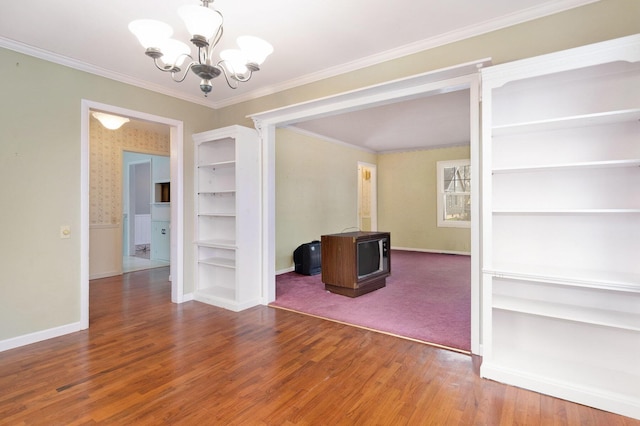 unfurnished dining area with hardwood / wood-style floors, crown molding, and a chandelier