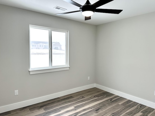 spare room featuring dark hardwood / wood-style floors and ceiling fan