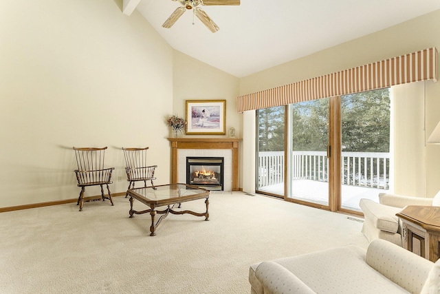 sitting room featuring a tile fireplace, ceiling fan, carpet floors, and high vaulted ceiling